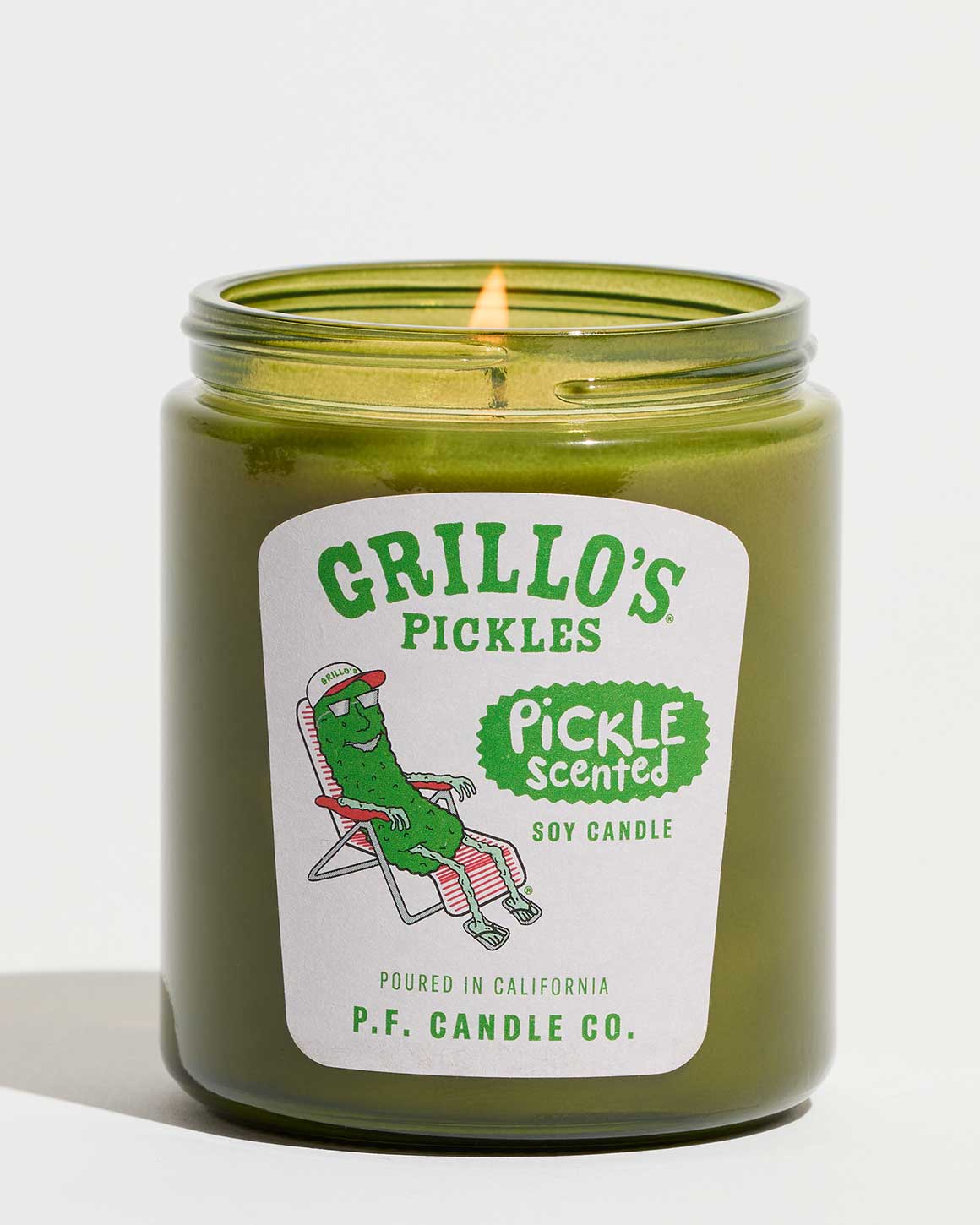 Green candle in a jar with 'Grillo's Pickles' label on a white background